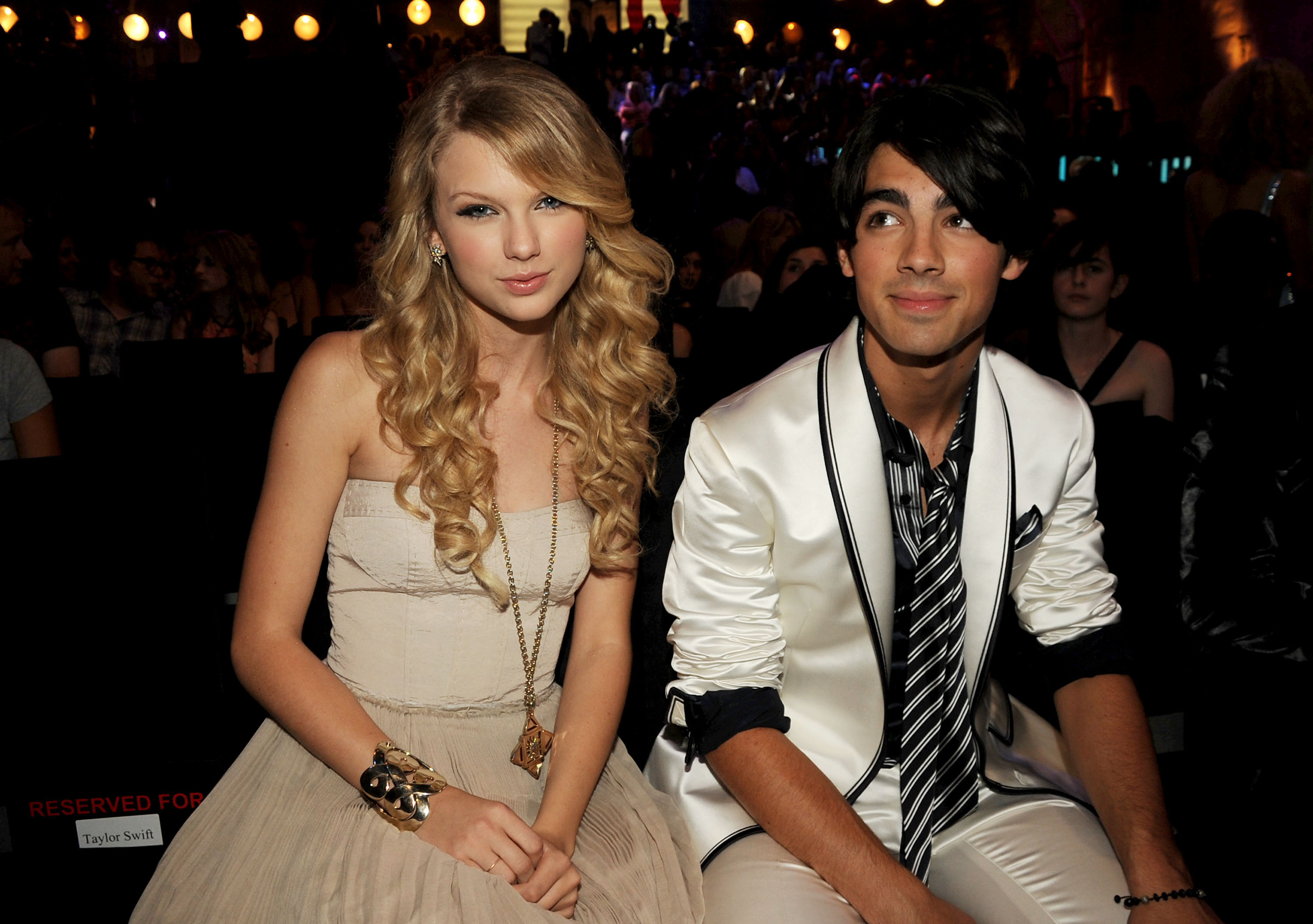 Taylor and Joe sitting next to each other at an awards show