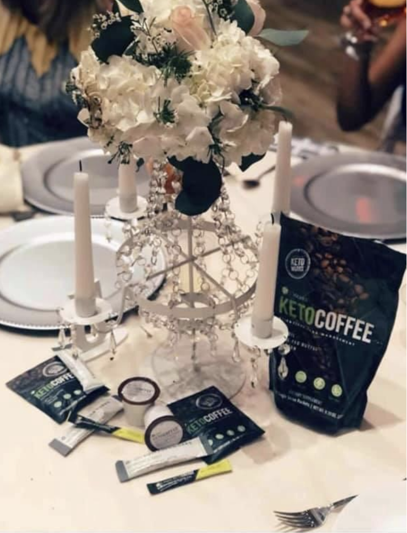 A bunch of products advertising something called Keto Coffee are laid out as the centerpiece on every table at the reception