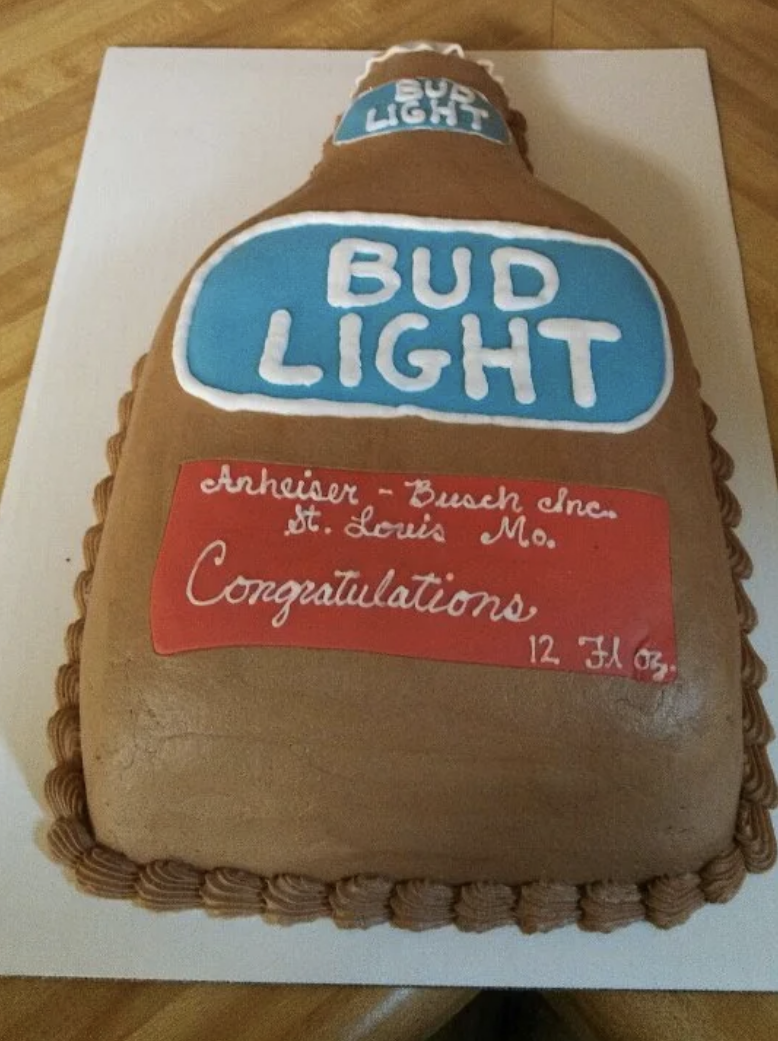 The wedding cake is made to look like a giant Bud Light bottle