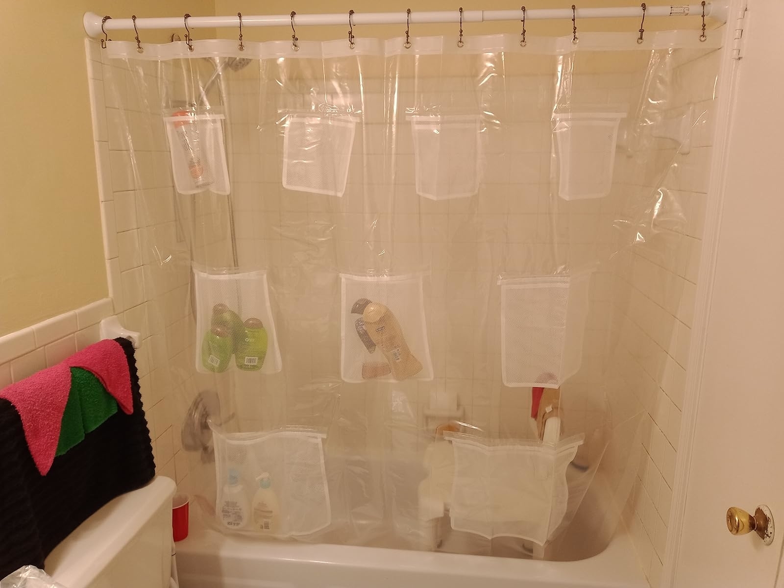 Reviewer image of the clear shower curtain hanging in their bathroom