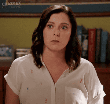 a woman putting her face to her hand in shock