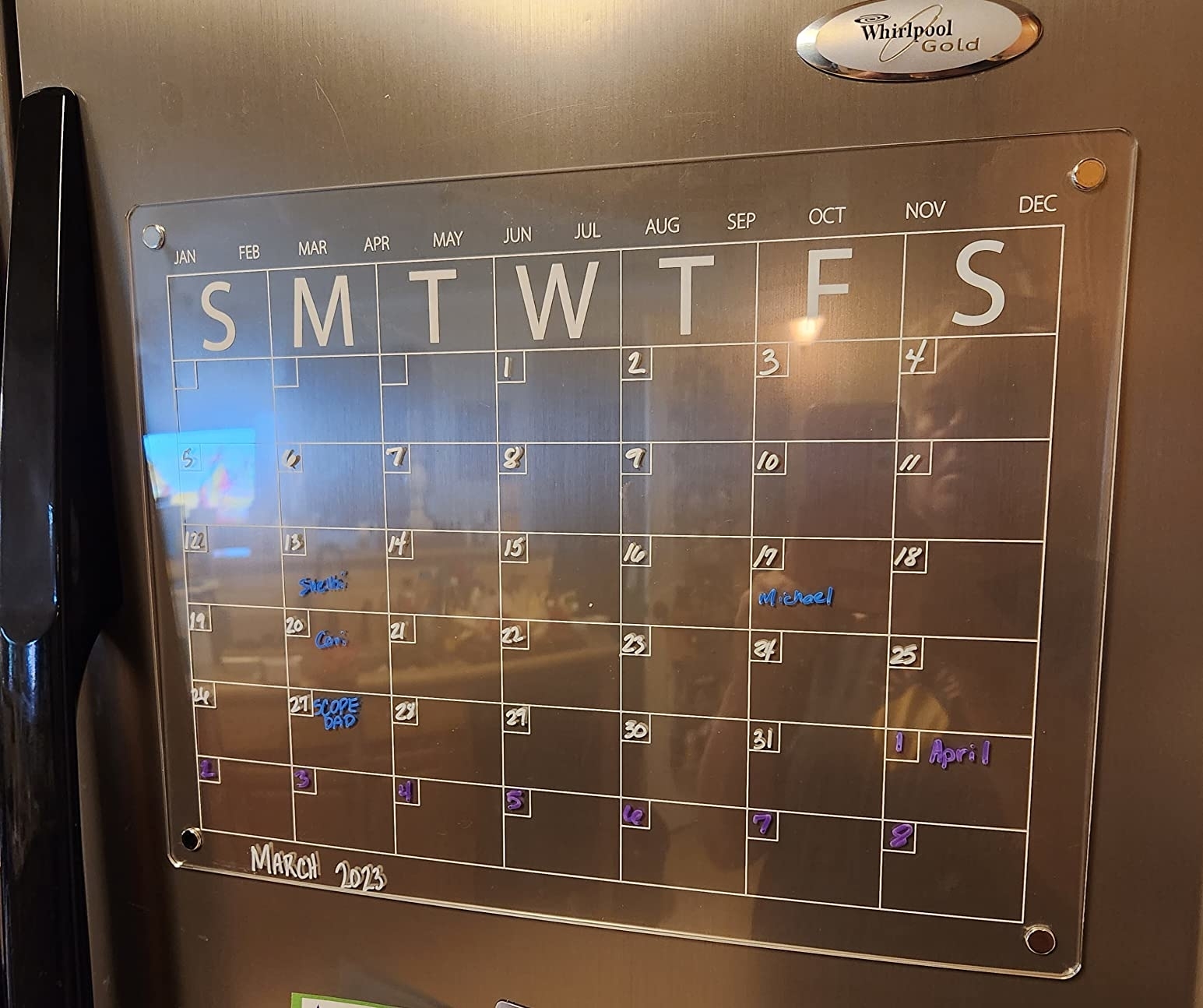 Reviewer image of the clear acrylic calendar on their fridge