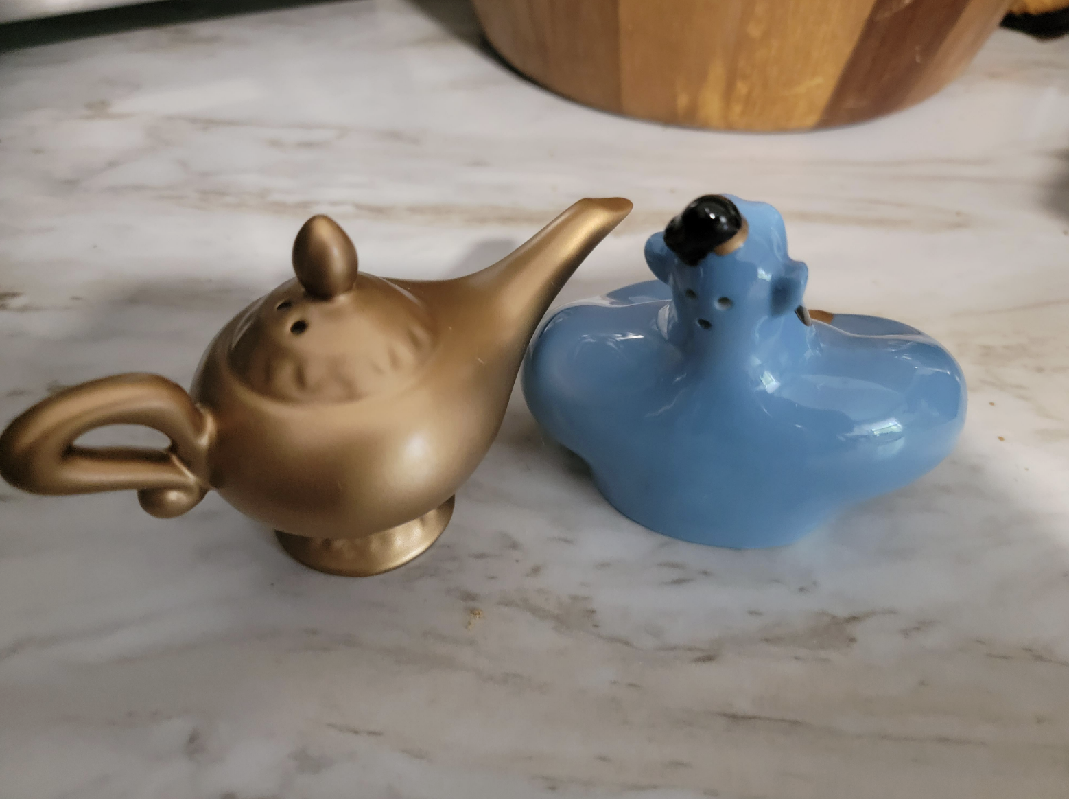 The salt shaker is shaped like the magic lamp from Aladdin, but the salt comes out two holes drilled in the top of the lamp, meaning you have to fully turn it upside down