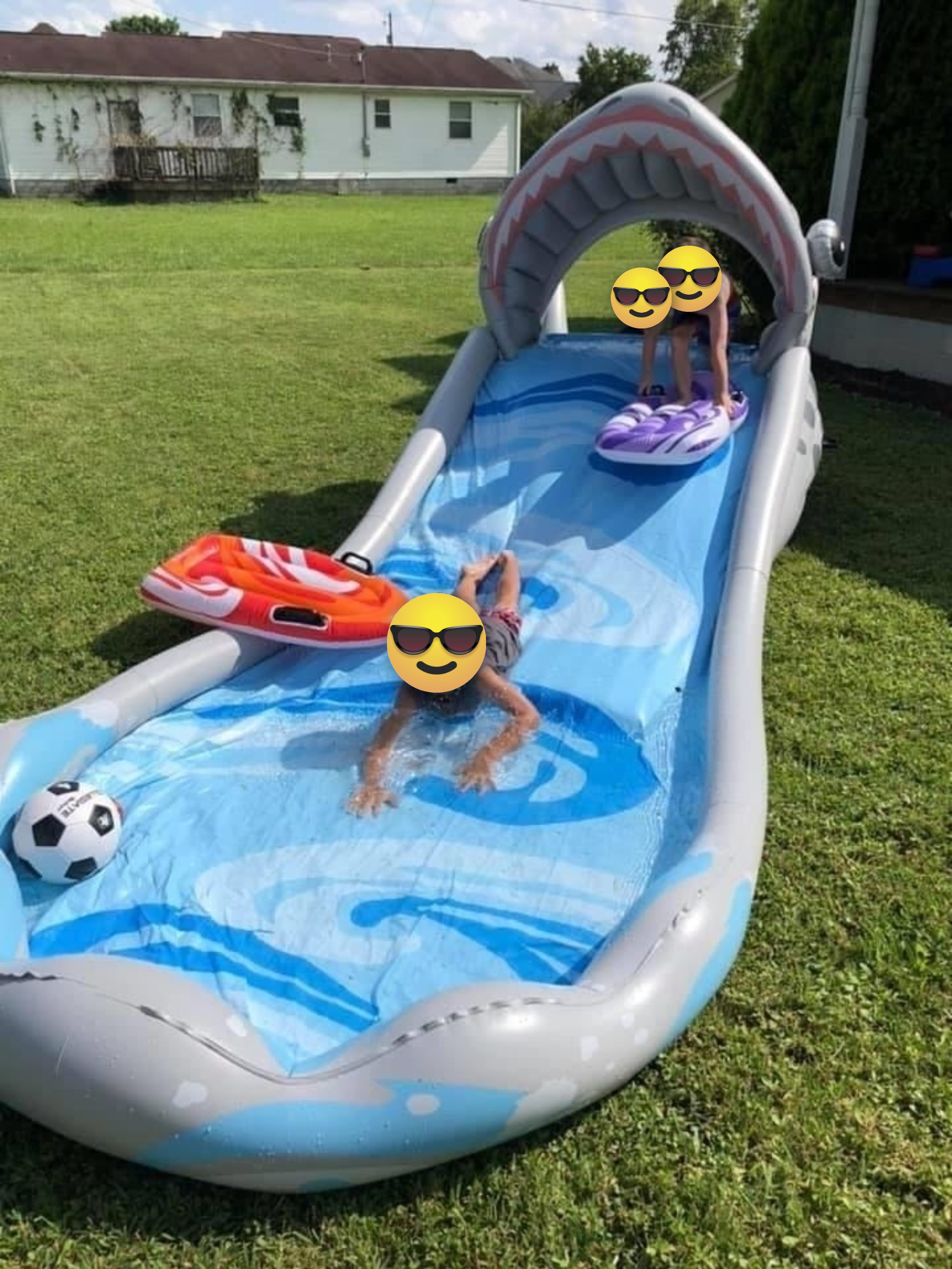 Kids slide down a water slide
