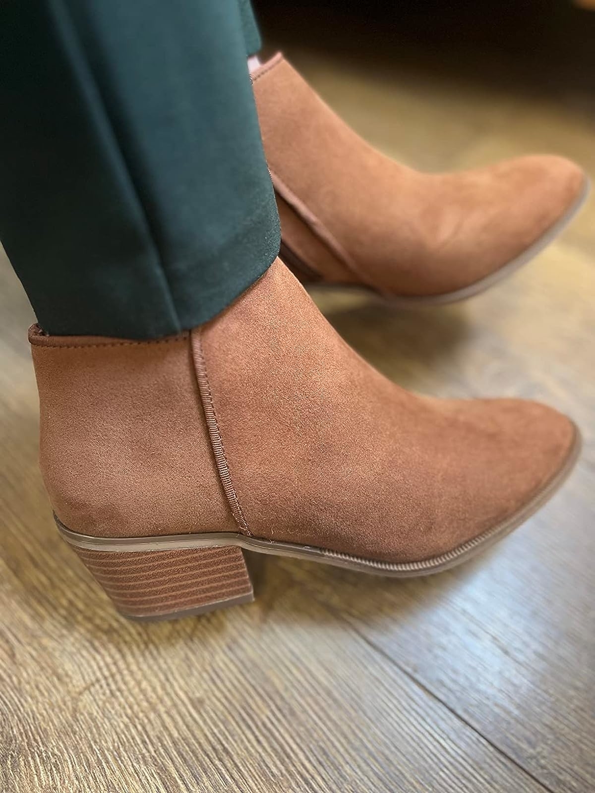 Reviewer wearing the brown suede ankle boots