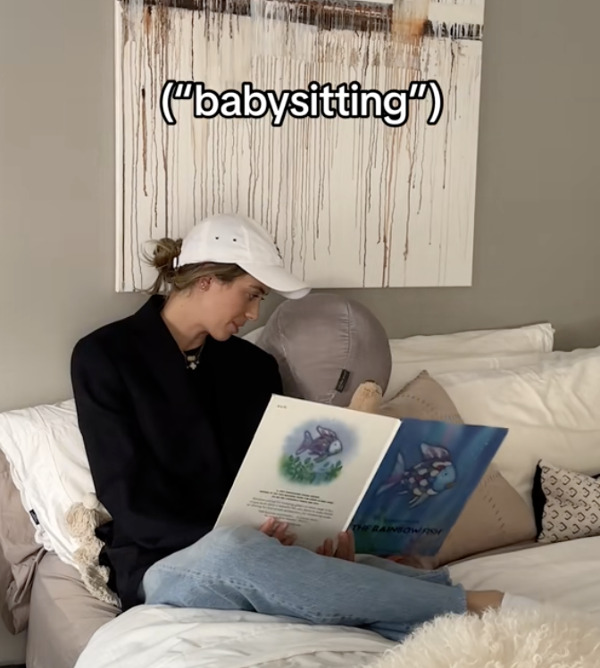 Dad reading a child a book in bed with caption &quot;babysitting&quot;