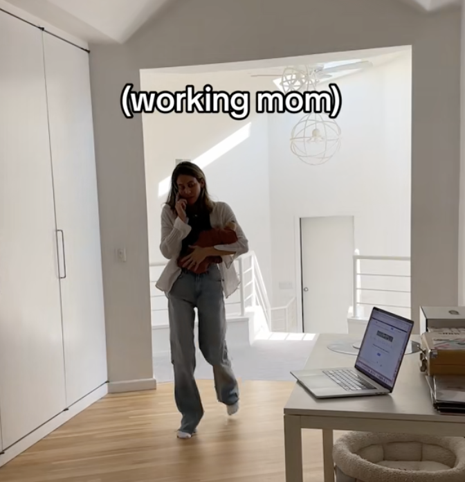 Mom on the phone carrying a baby with a laptop on a desk with caption &quot;working mom&quot;