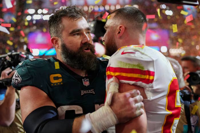 Jason and Travis Kelce hugging on the field