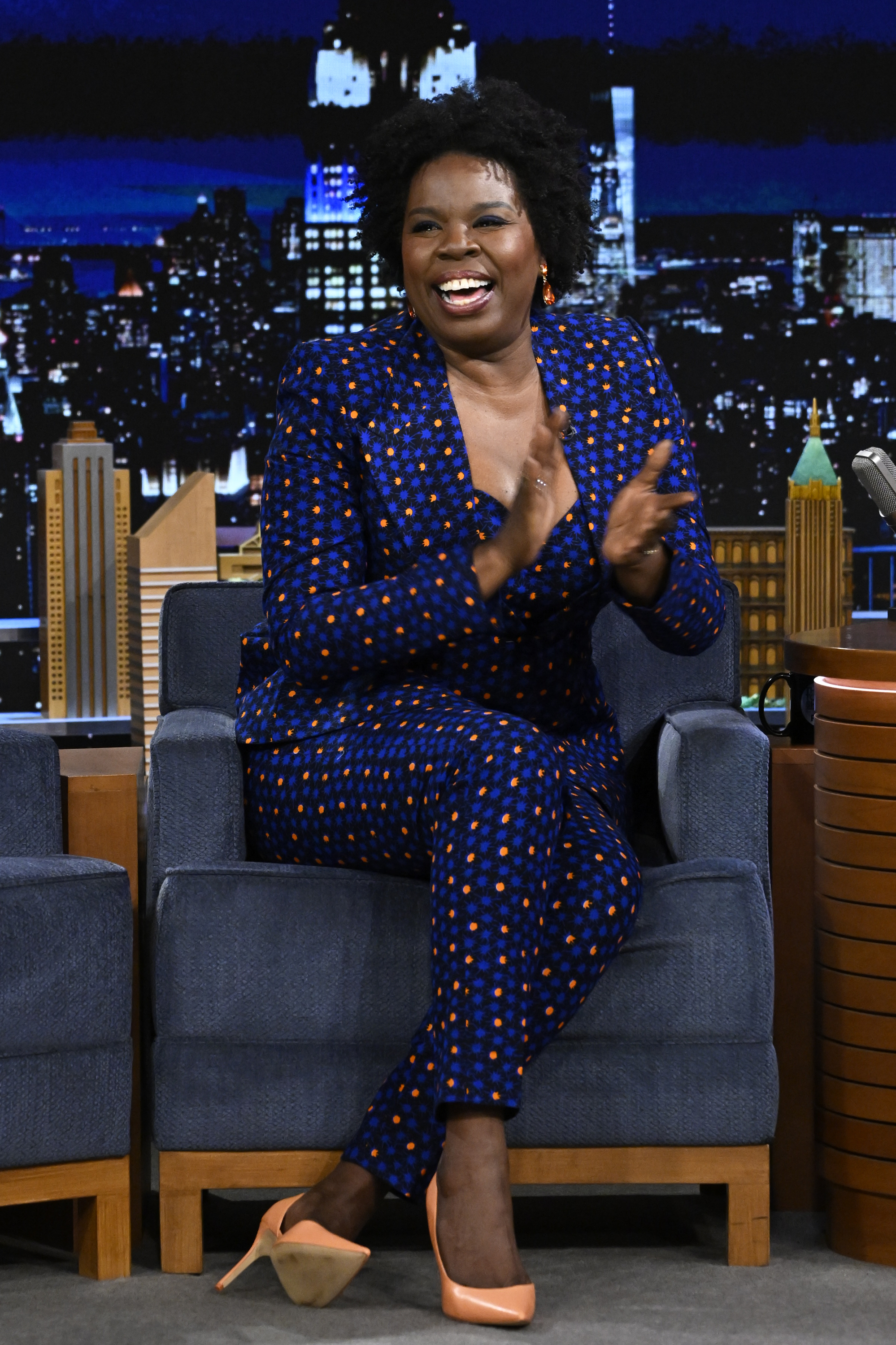 Closeup of Leslie Jones sitting on stage for a late-night TV talk show