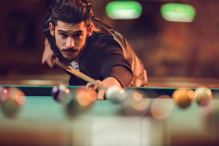 man playing pool