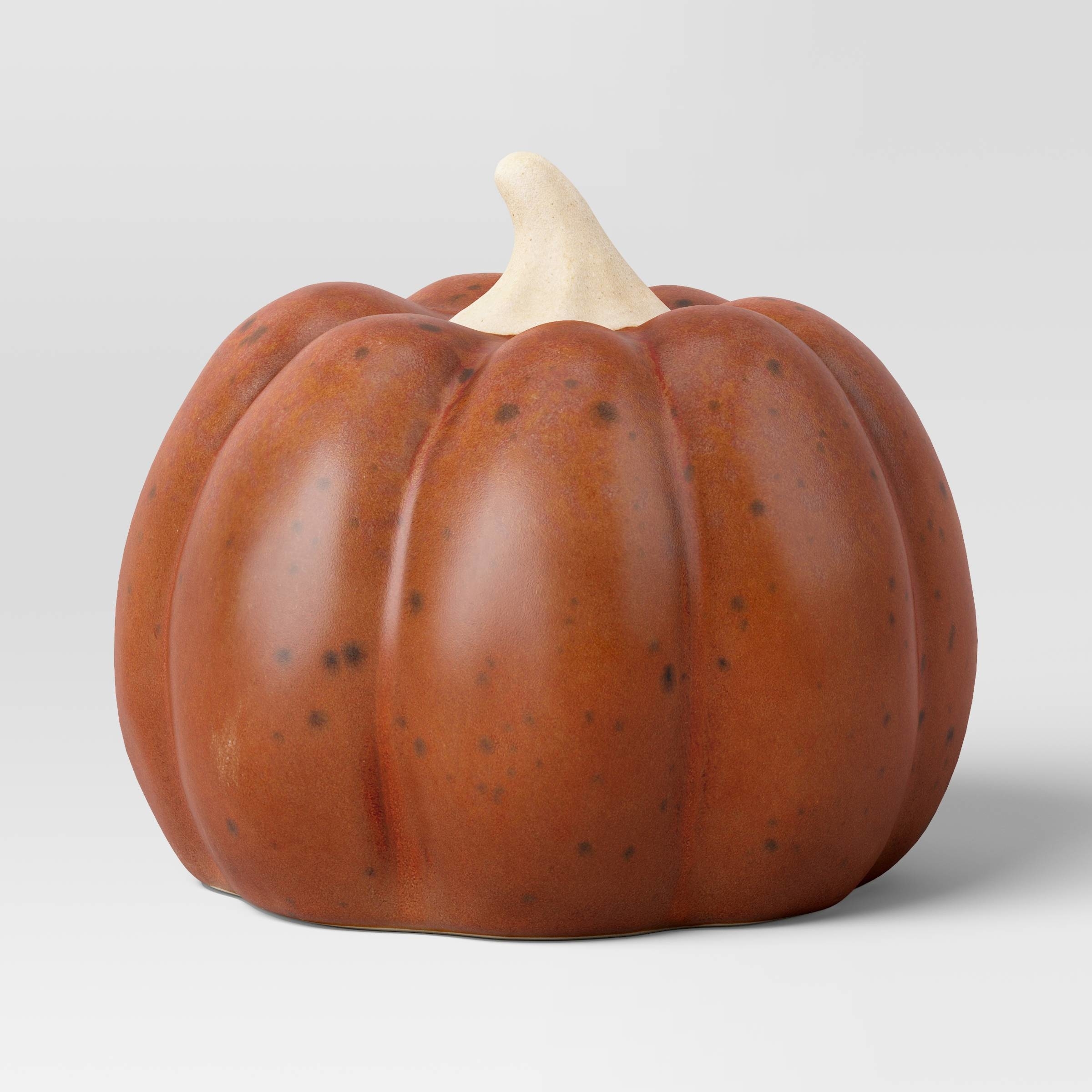 the ceramic pumpkin with a rust-color