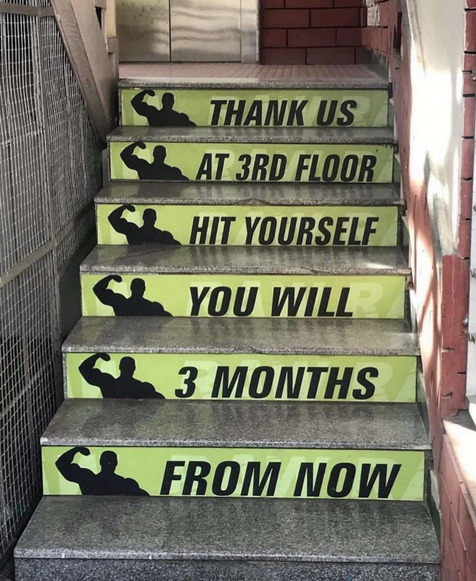 The beams between stairs have signs that when read from top to bottom, say &quot;thank us at third floor, hit yourself you will three months from now&quot;