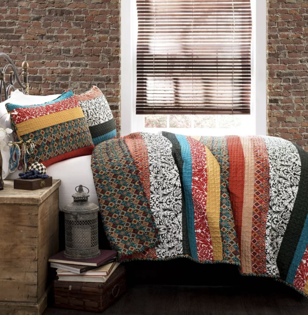 the colorful quilt on a bed