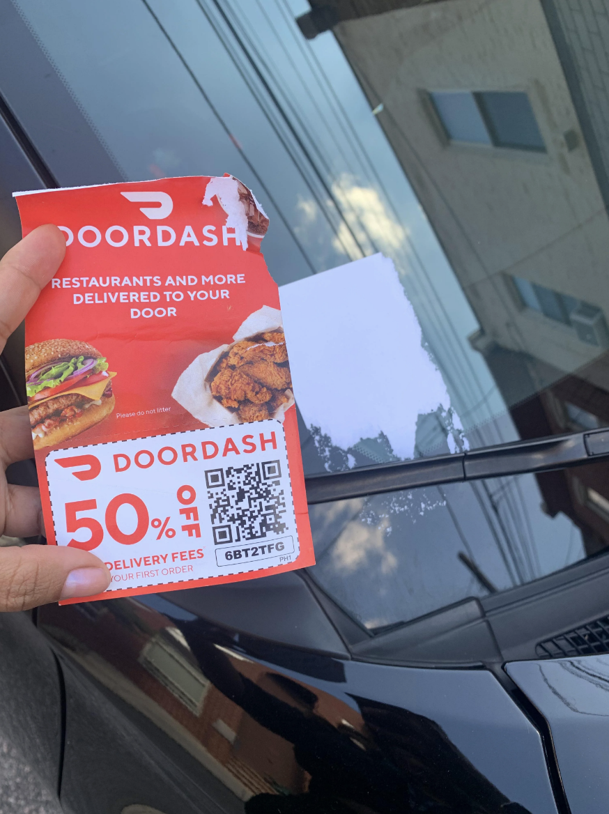 The sticker is a DoorDash coupon, and when it was pulled off the windshield, it left a very large piece of sticky residue