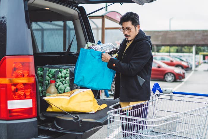 A man loading groceries into his car