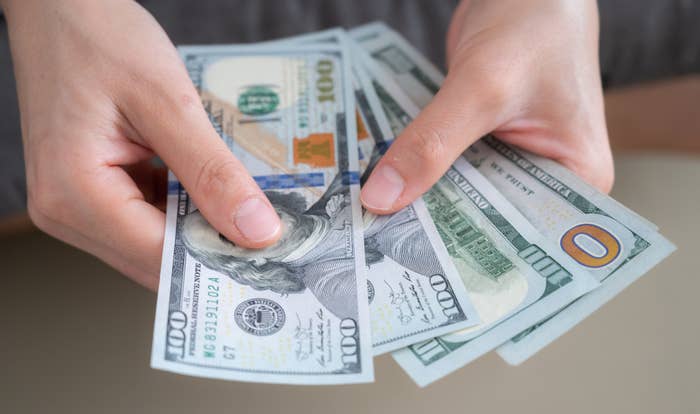 Someone holding out cash