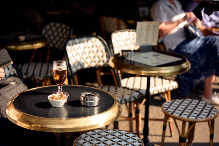a row of outdoor tables at a parisian cafe