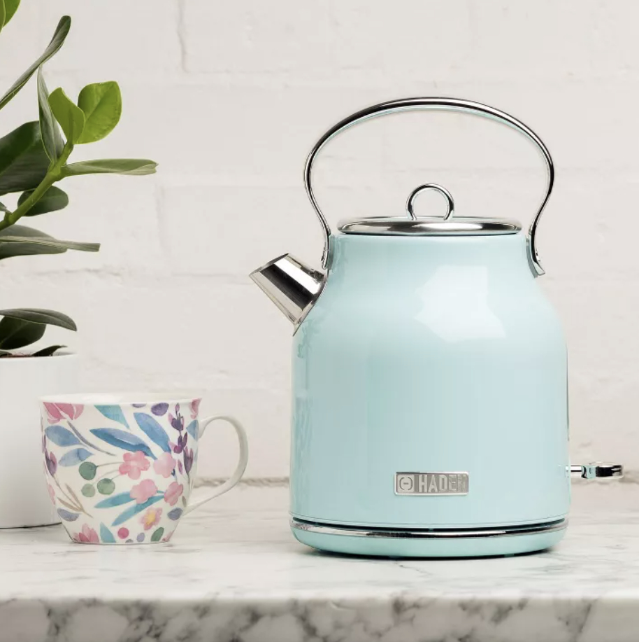 the turquoise tea kettle on a stove