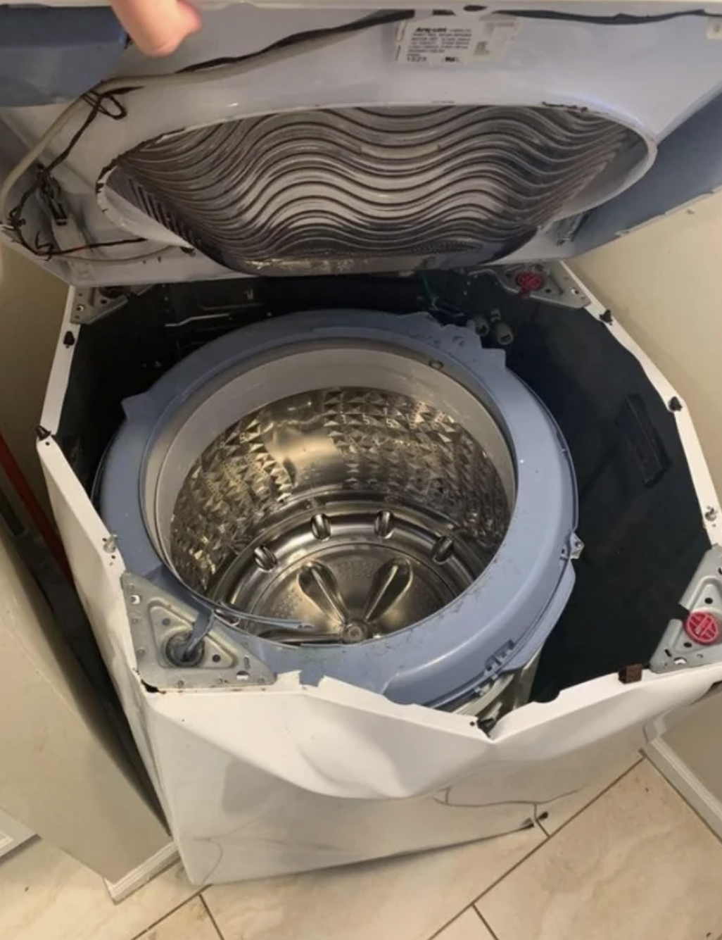 a completely damaged and wrecked washer