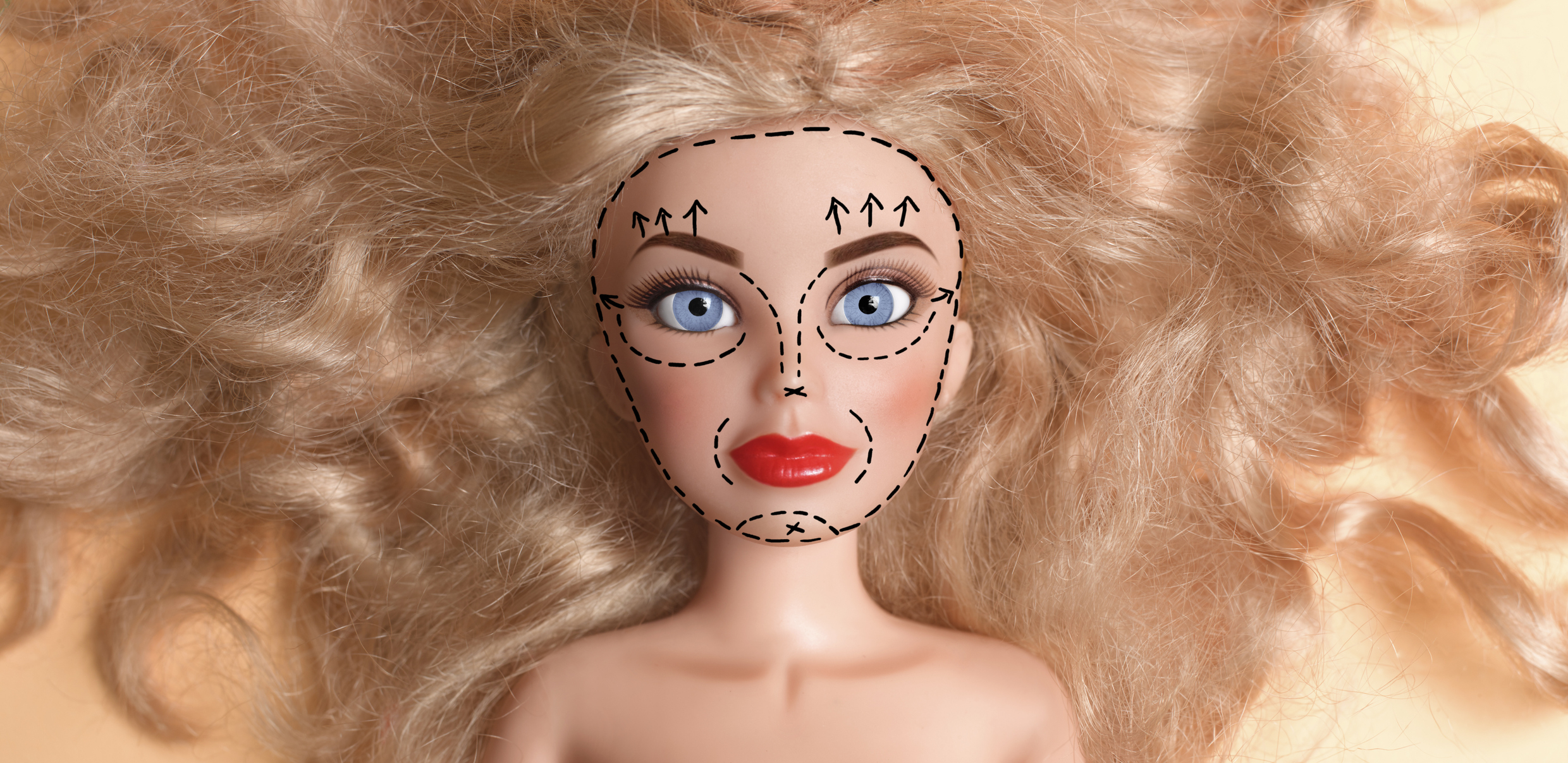 A doll with surgery markings on its face