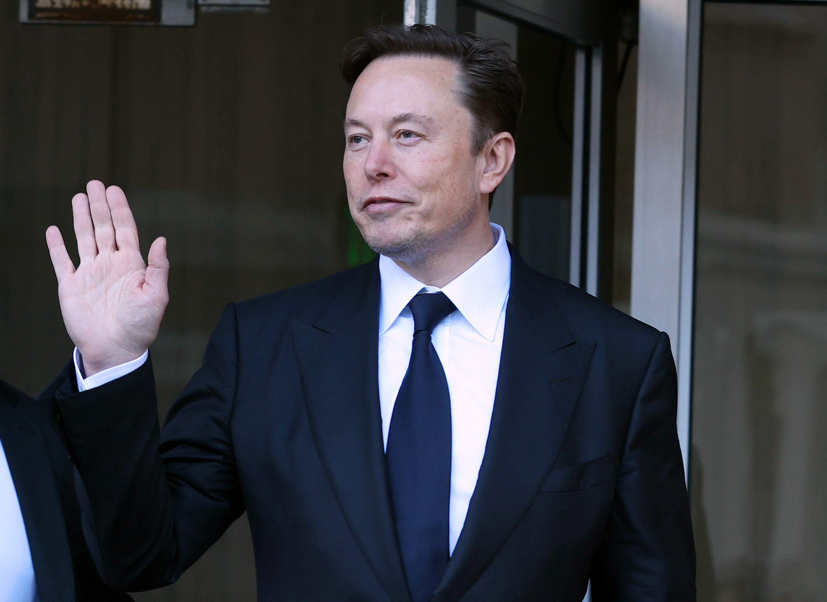 Closeup of Elon Musk waving