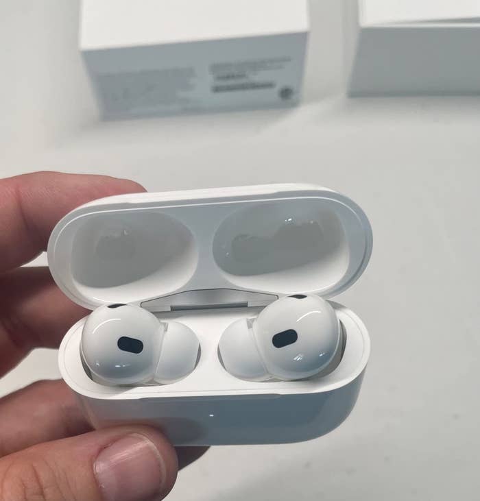 Reviewer&#x27;s photo of the AirPods in their case