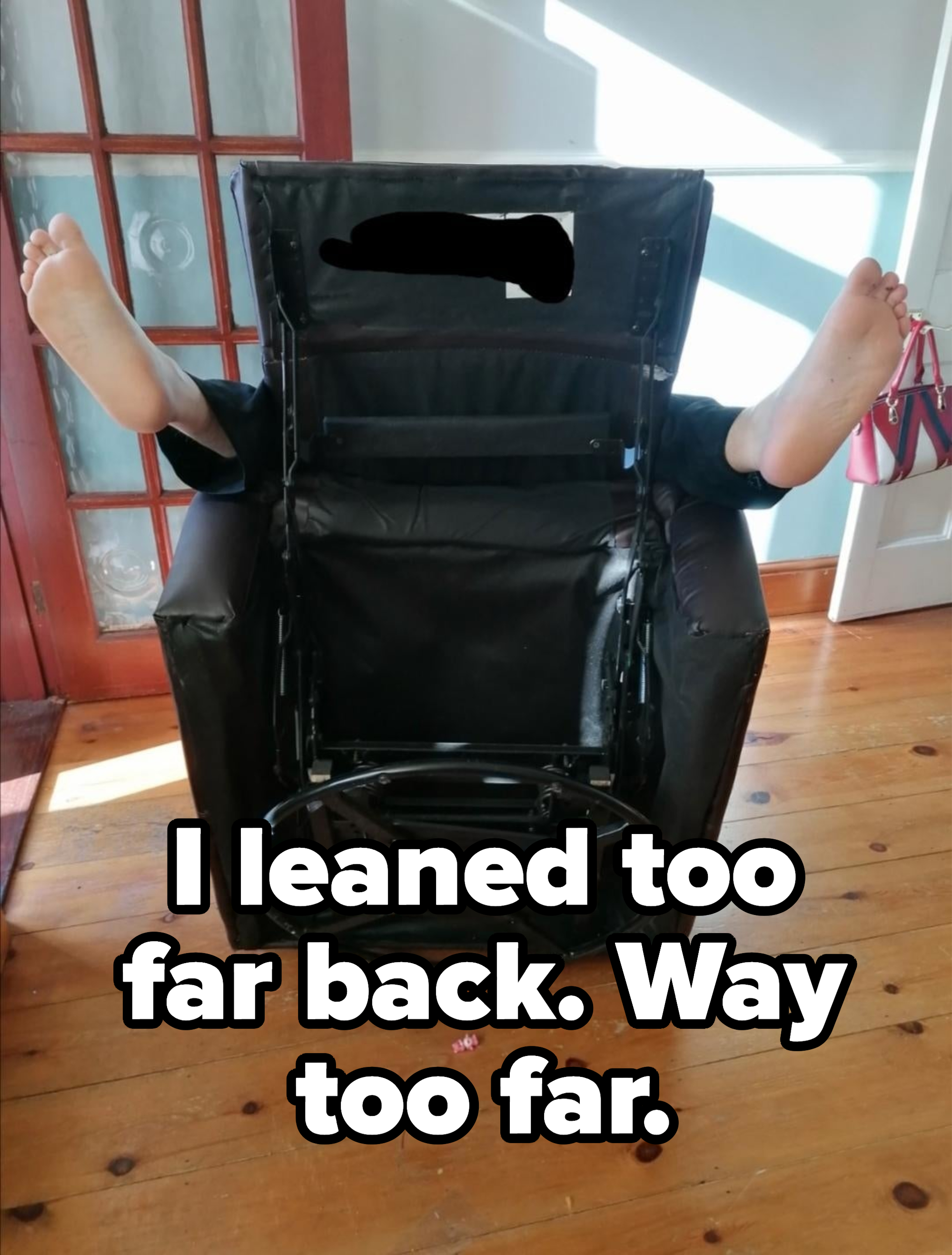 View of a reclining chair with the seat upended, with two legs emerging from the sides, with caption "I leaned too far back, way too far"