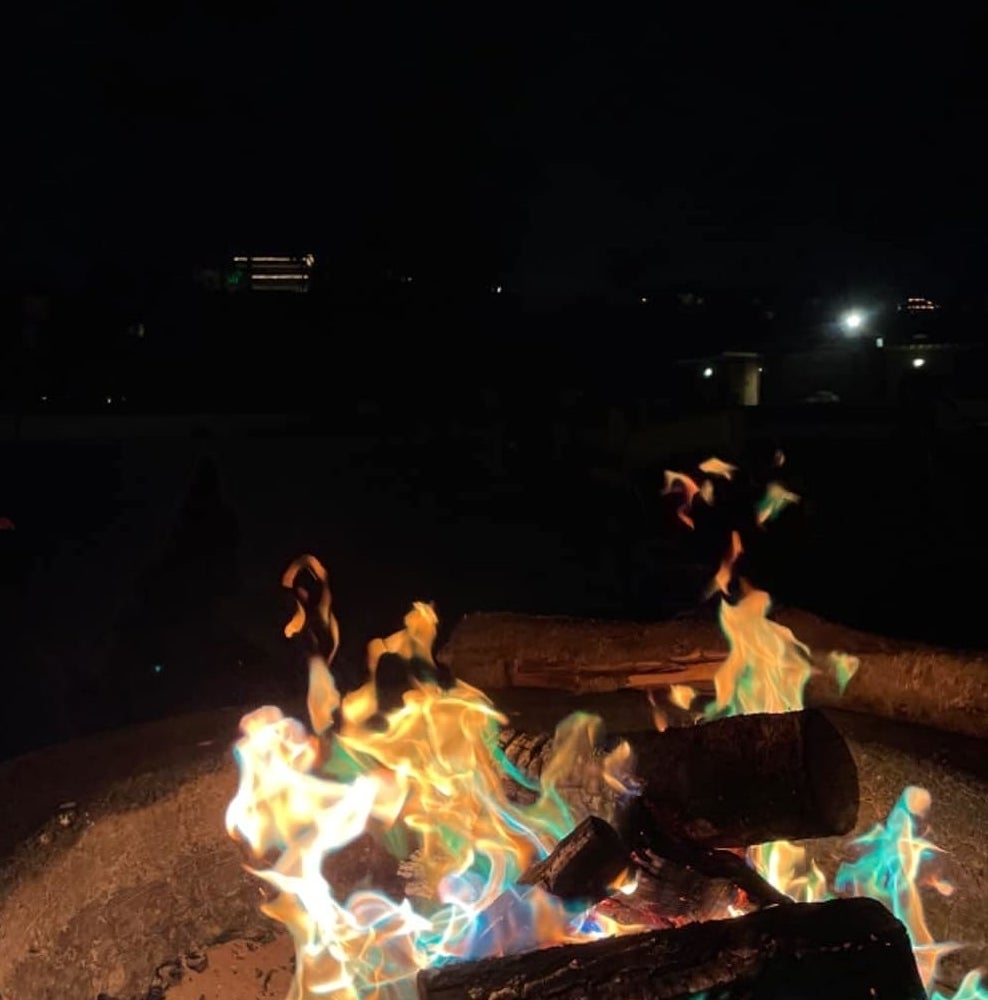 Reviewer&#x27;s photo of a colorful fire created using the flame colorant