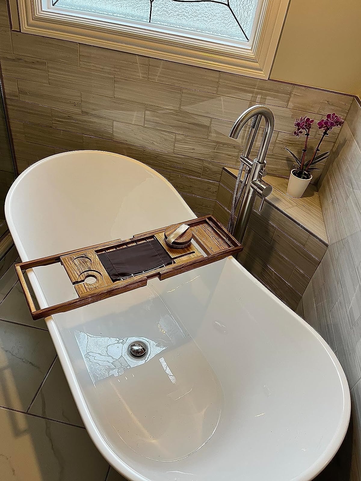 Reviewer&#x27;s photo of the bath tray set on a white bathtub