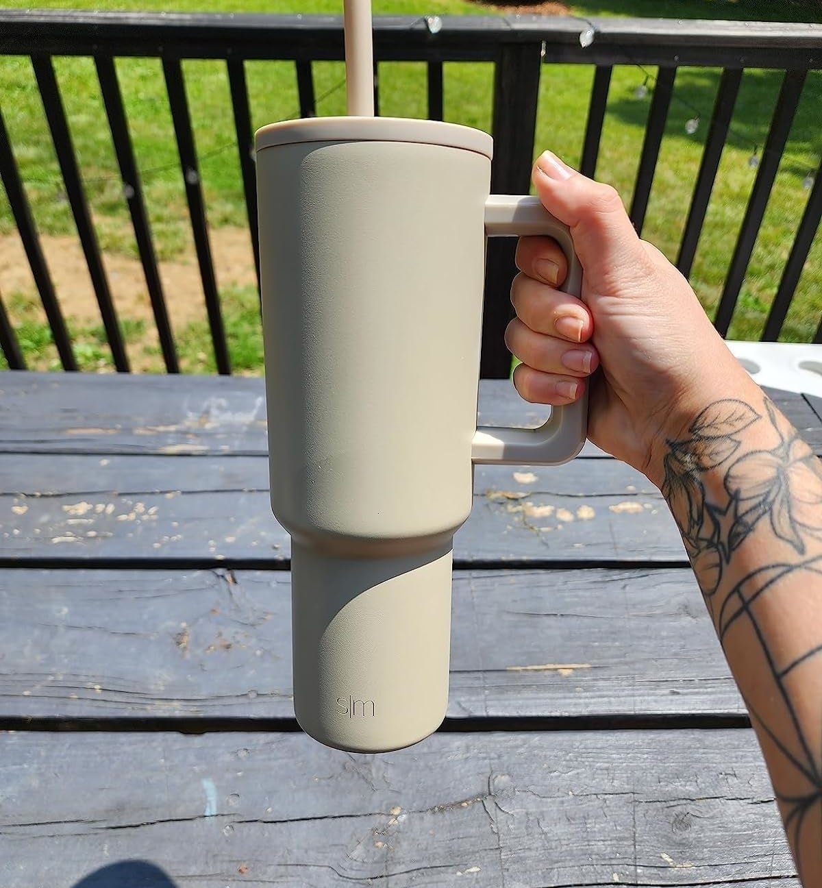 Reviewer&#x27;s photo of them holding the tumbler in the color Almond Birch