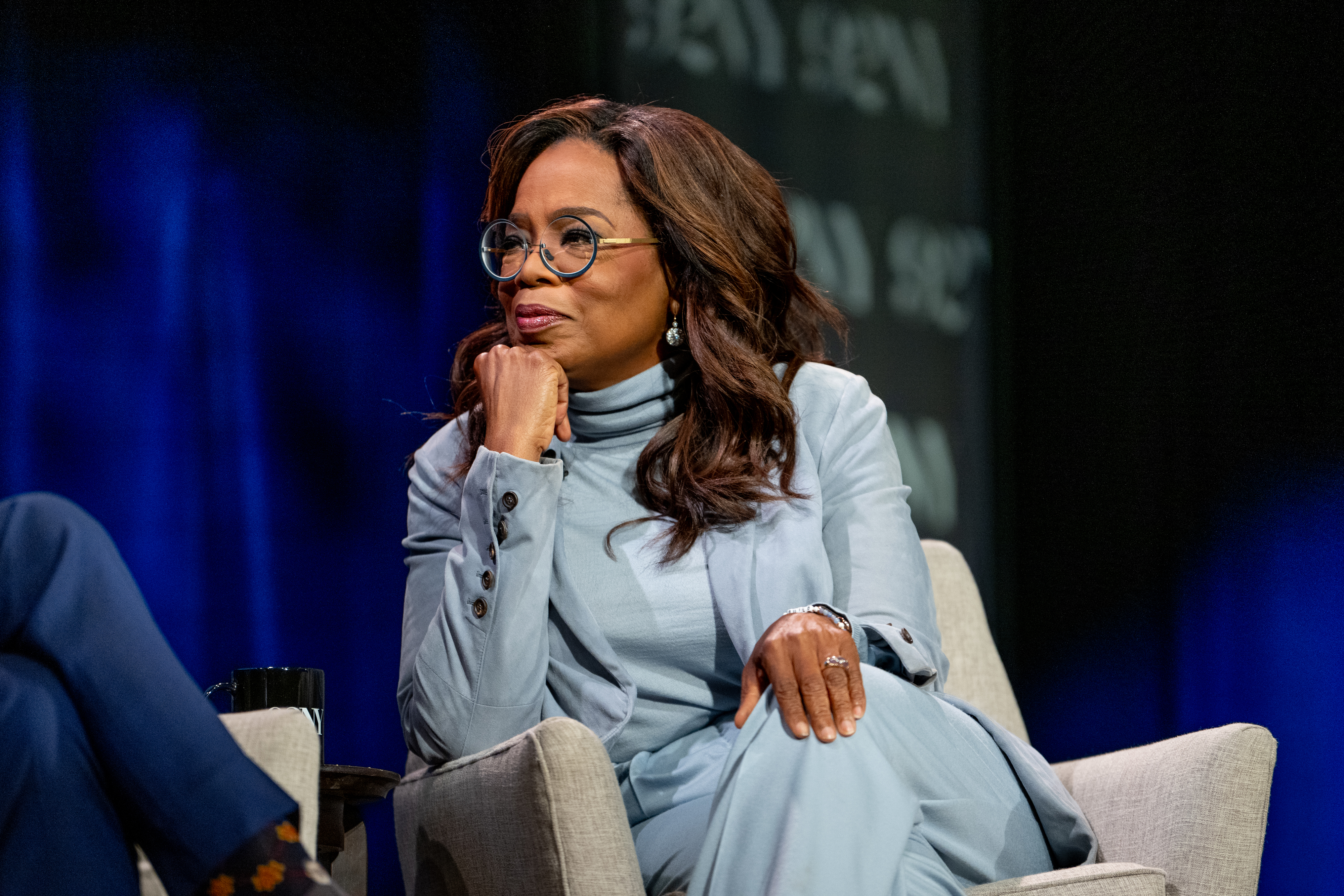 Close-up of Oprah seated onstage