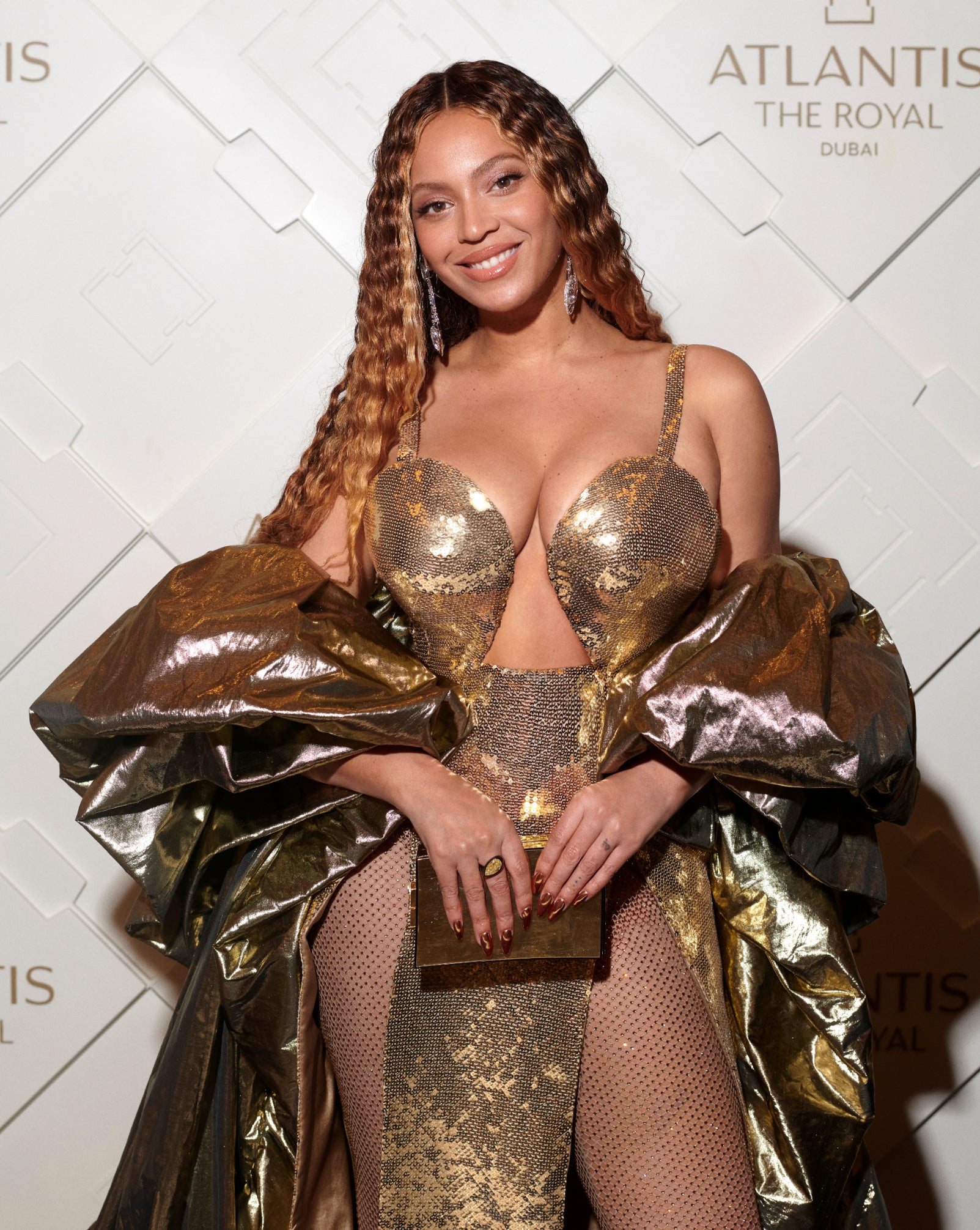 she's got her long hair in waves and she's wearing a sparkly dress