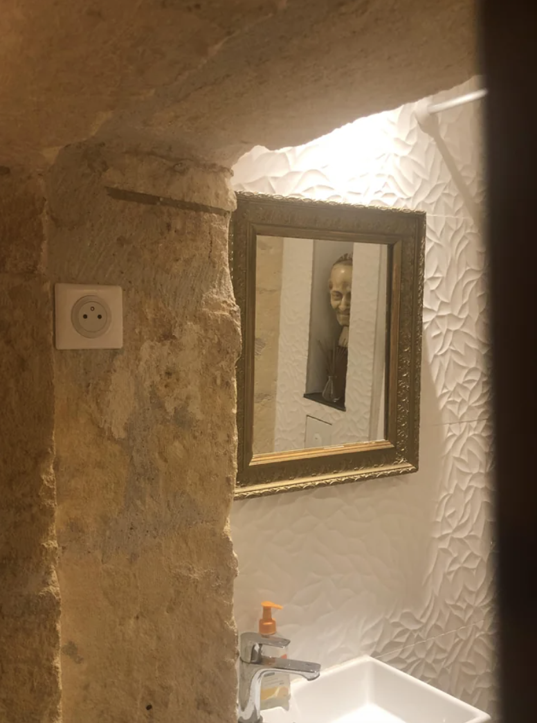 a scary bust reflected in a mirror