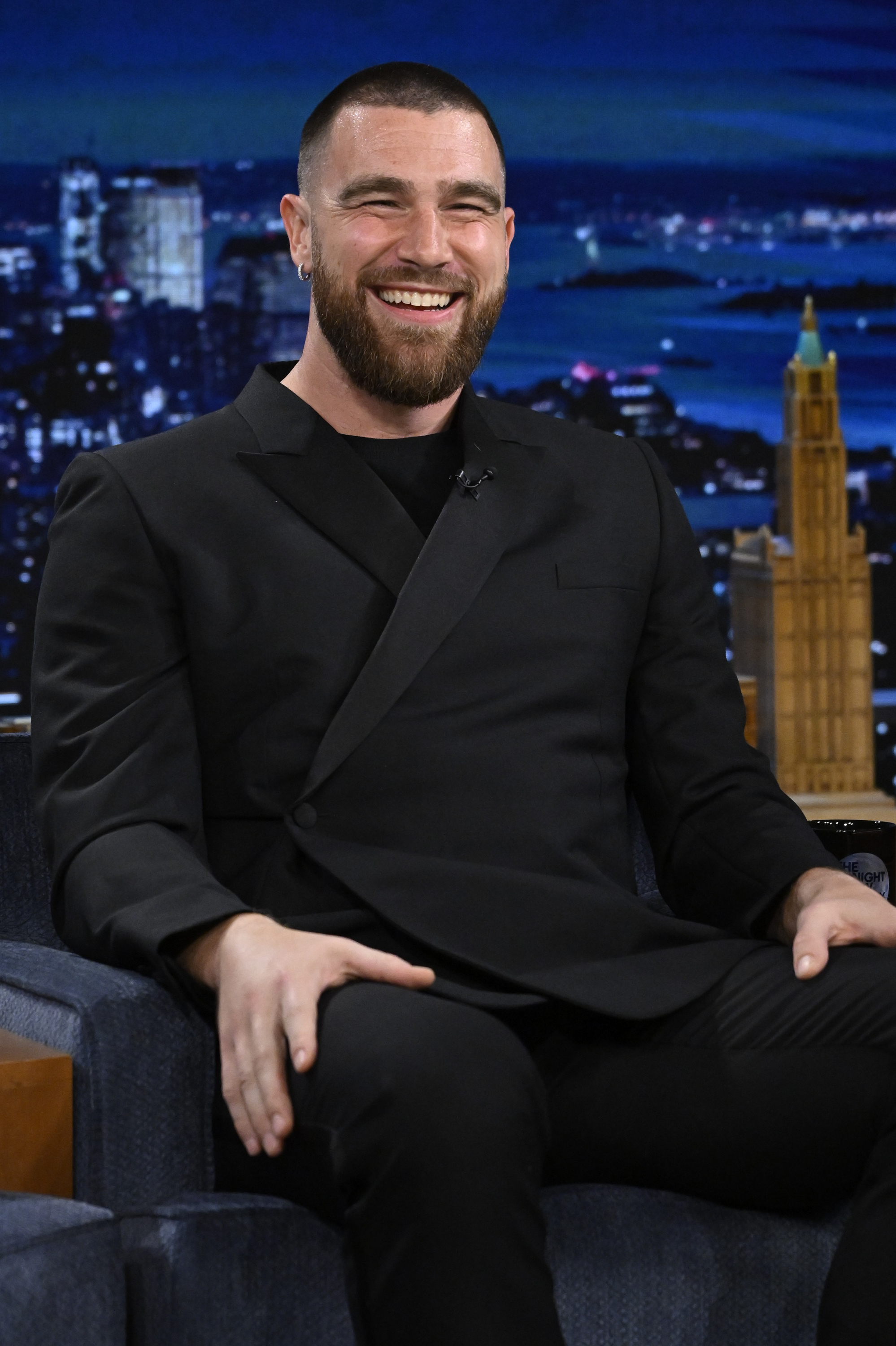 Close-up of Travis smiling on a talk show