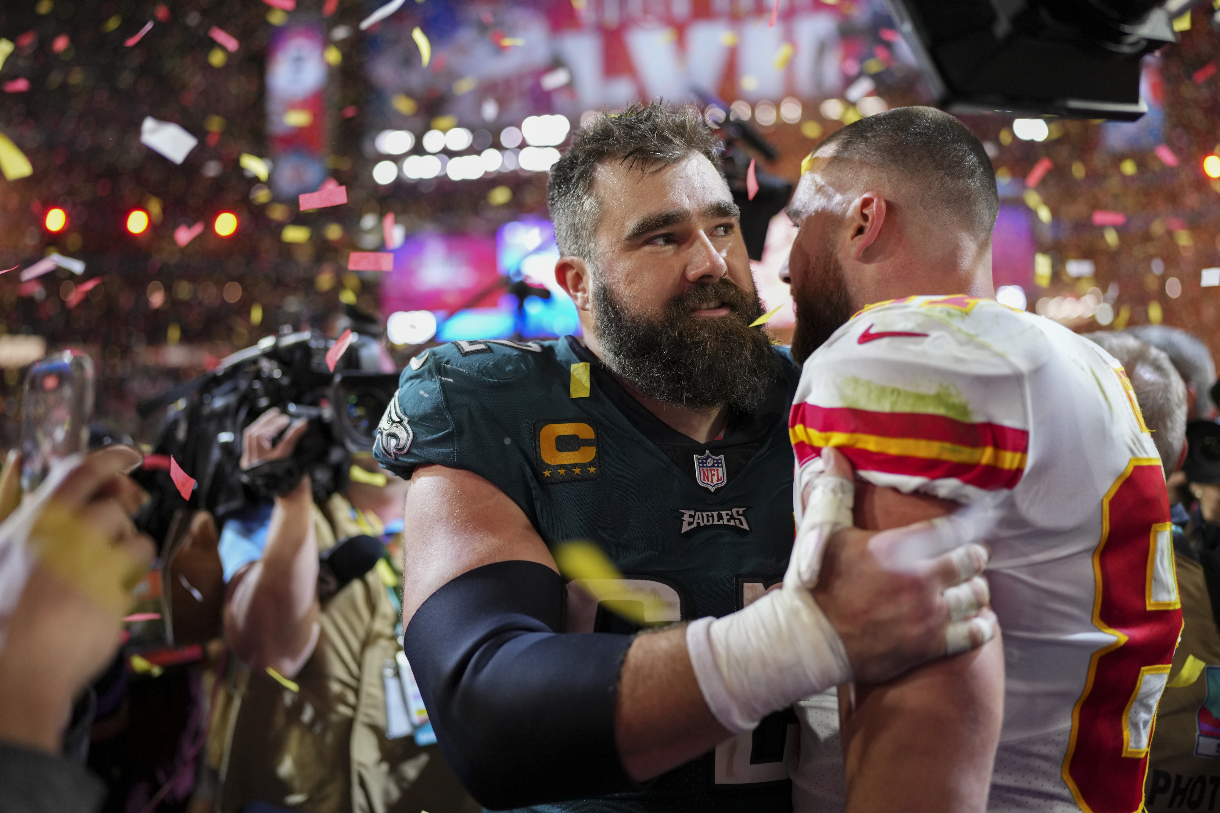 Close-up of Travis and Jason embracing on the football field