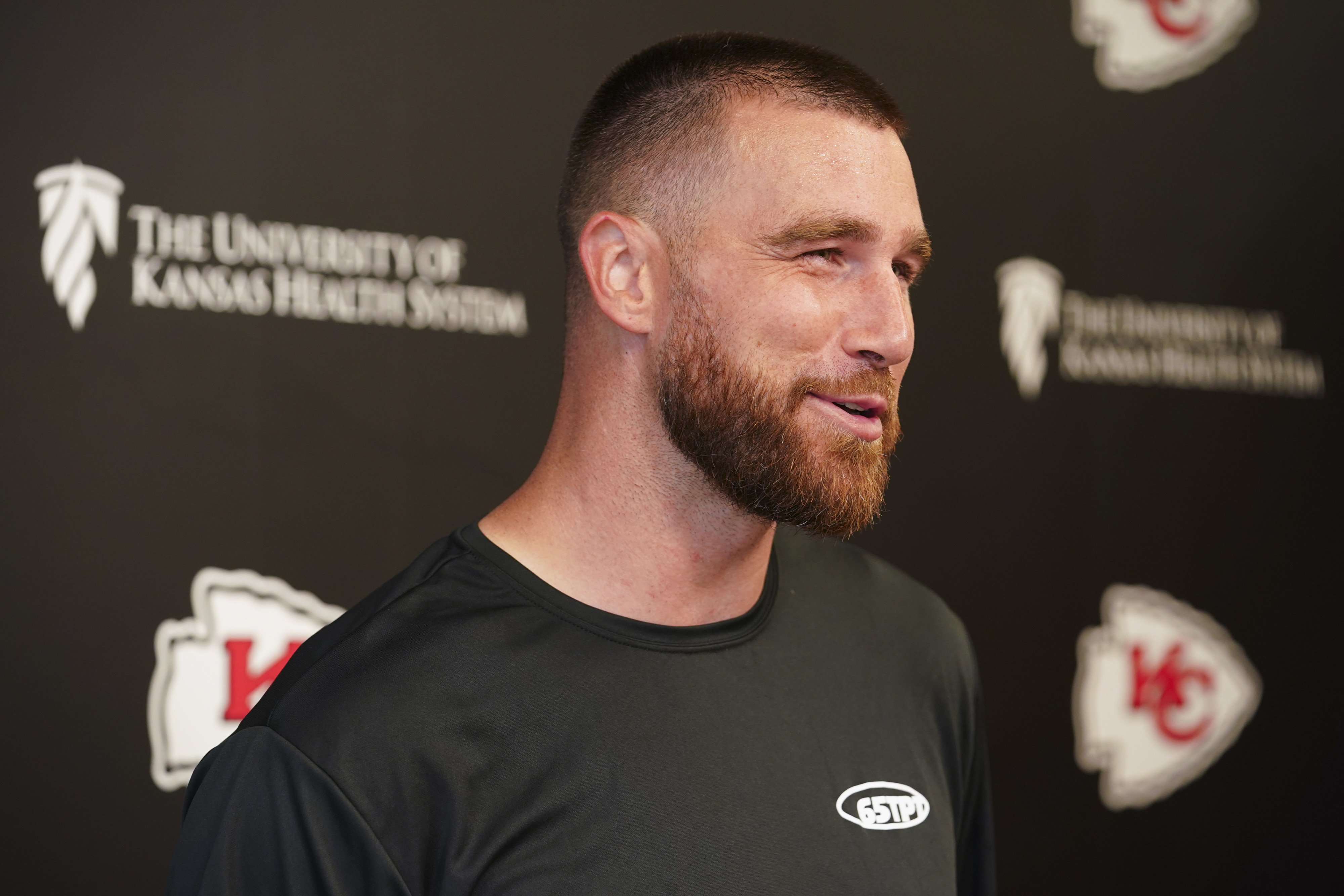 Close-up of Travis smiling at a media event