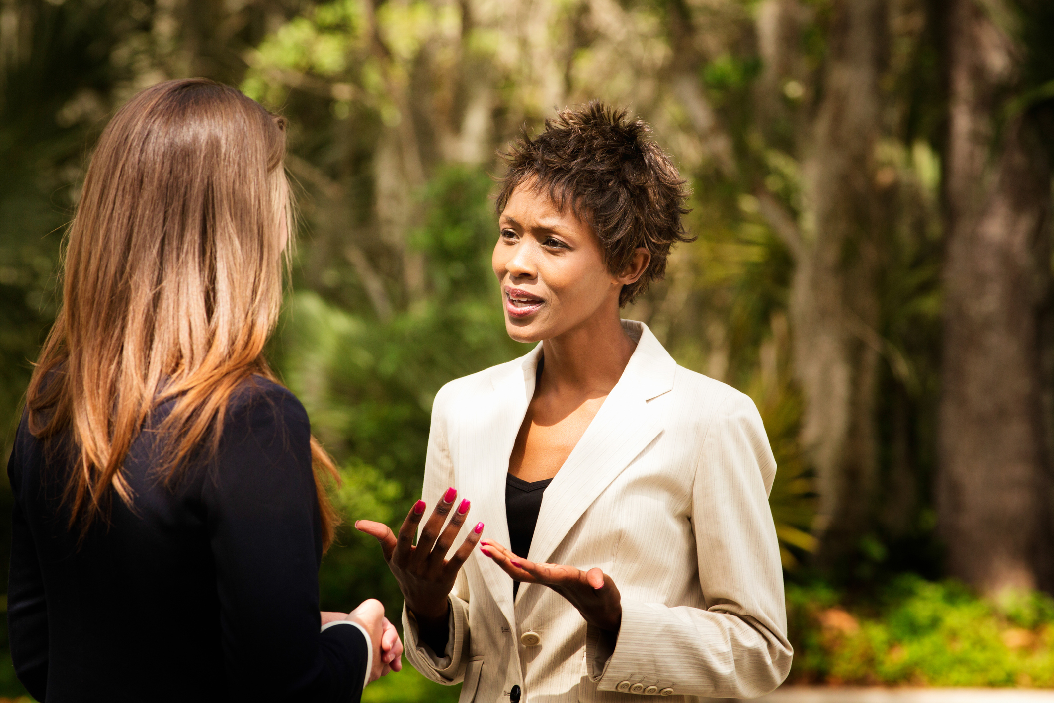 two women talking outside
