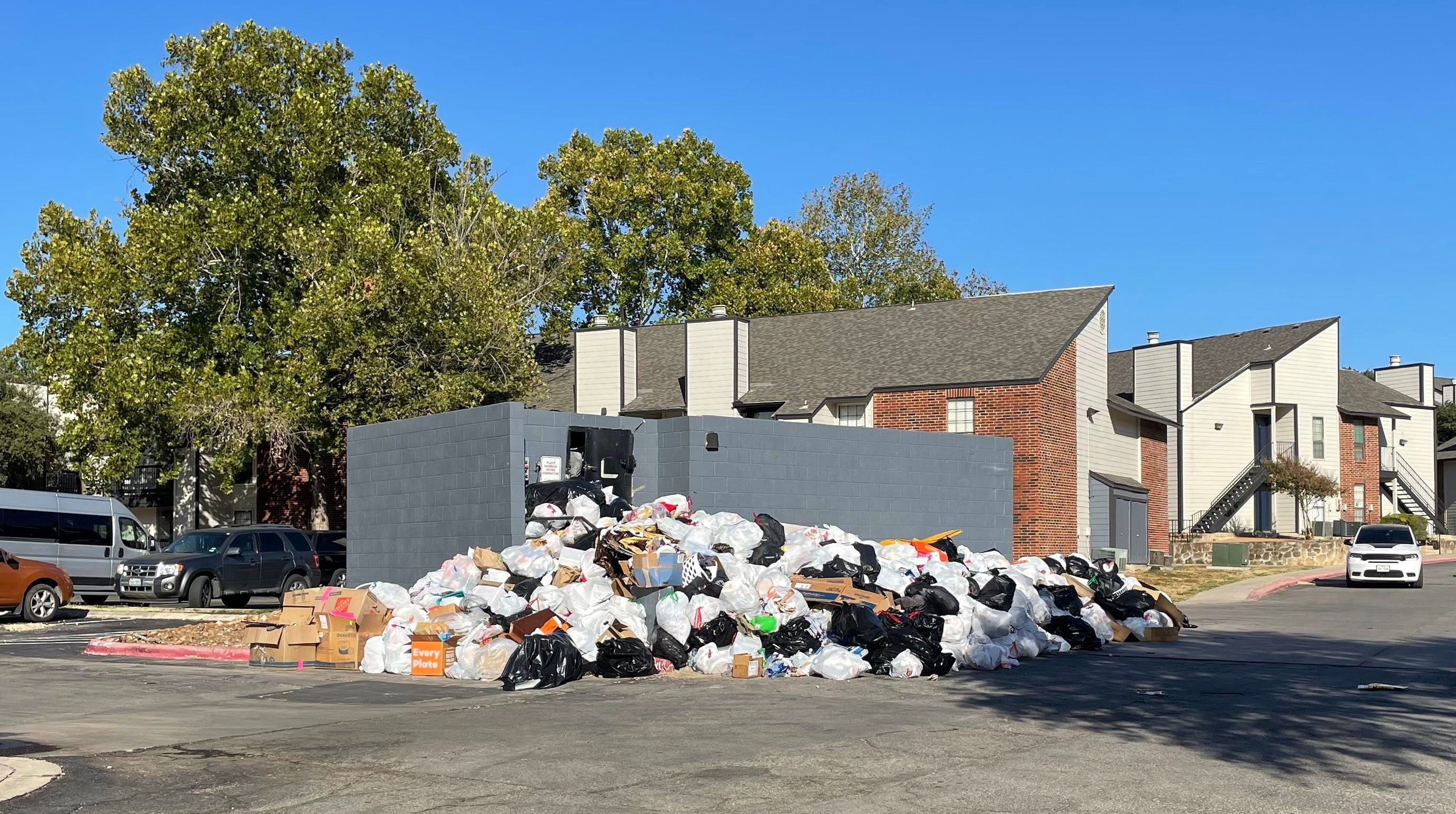 large pile of trash where a dumpster should be