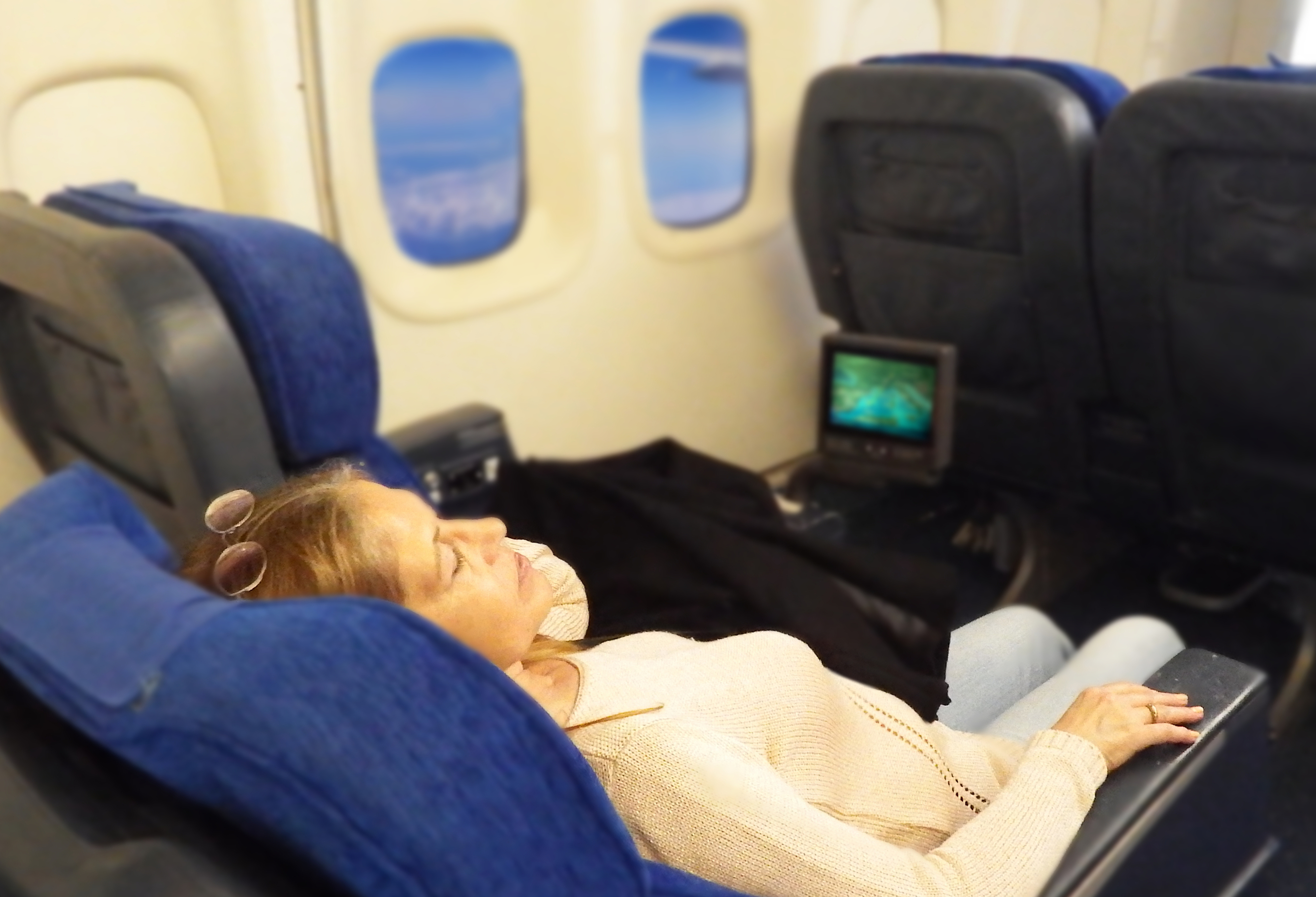 a person reclined on an airplane