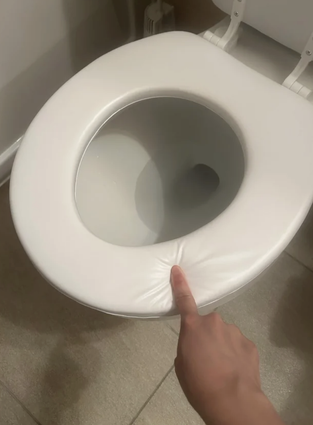 the toilet seat is the soft cushion one