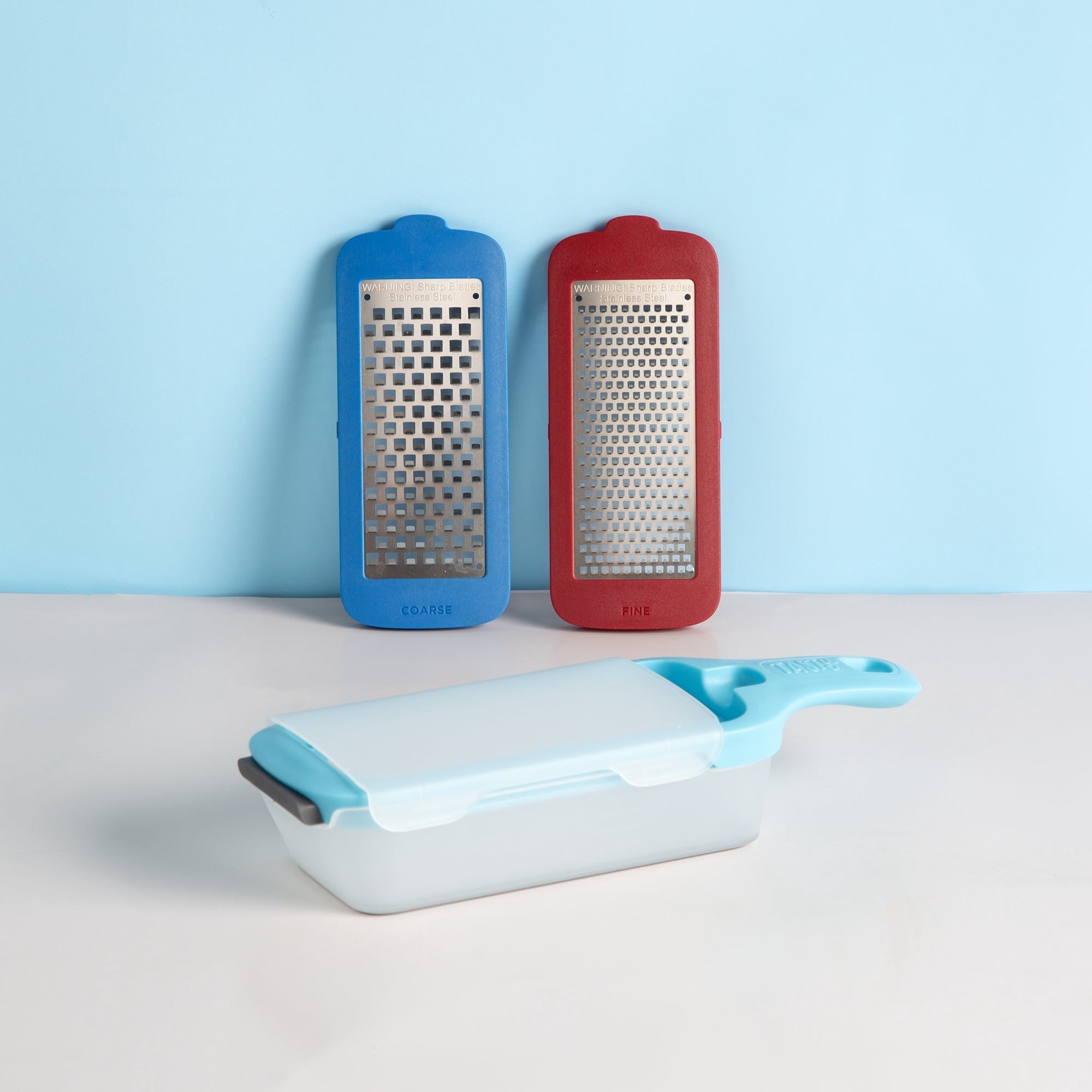 Blue and red interchangeable grater.