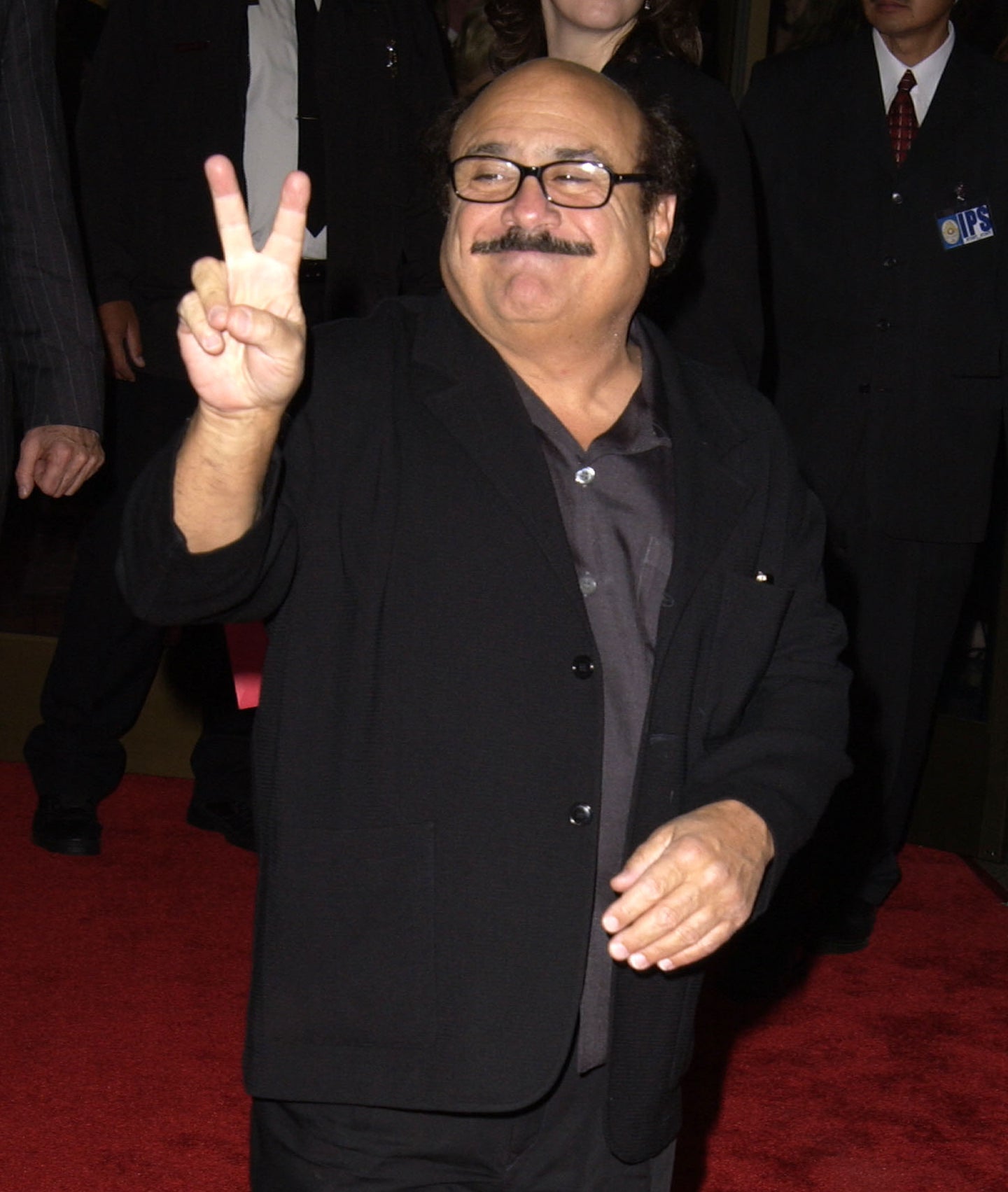 he&#x27;s got a mustache and glasses wearing a suit