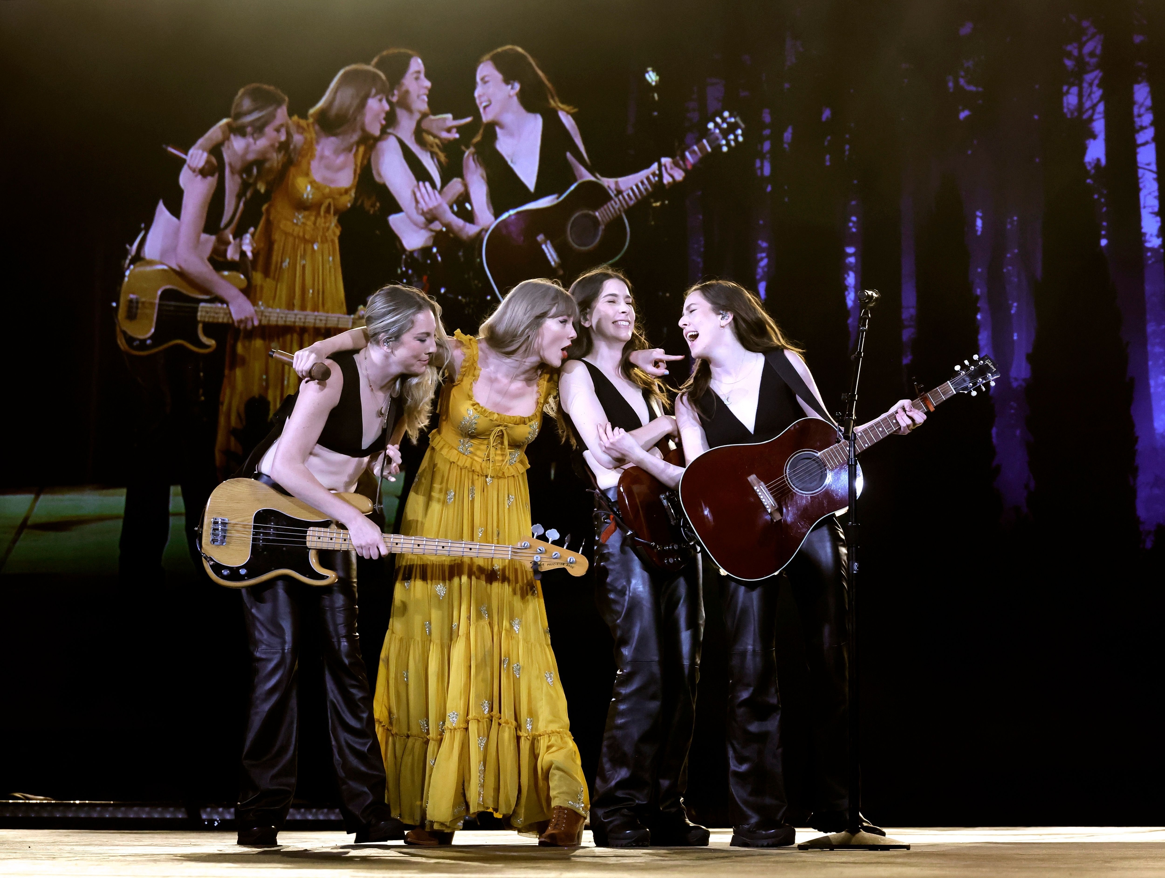 taylor on stage with the band