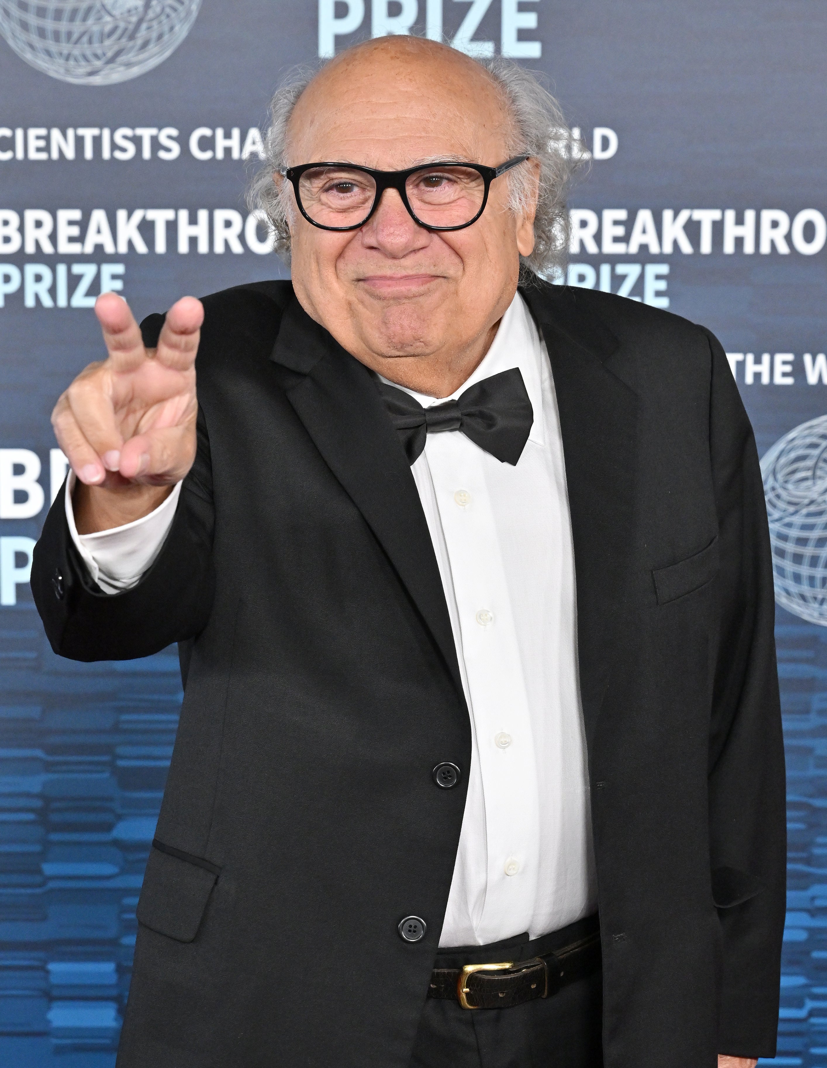 his hair is completely grey and he's got the same kind of glasses