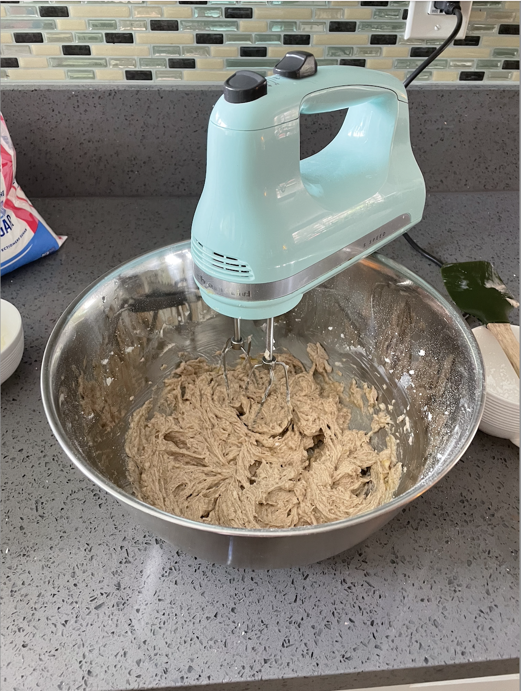 a hand-mixer in a bowl of cookie batter