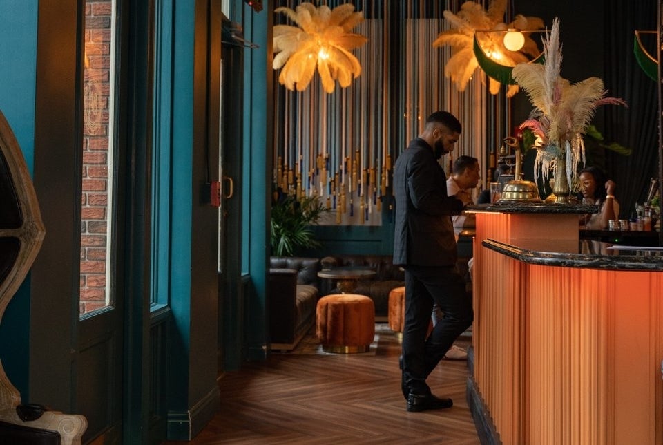Man orders drink at hotel themed bar