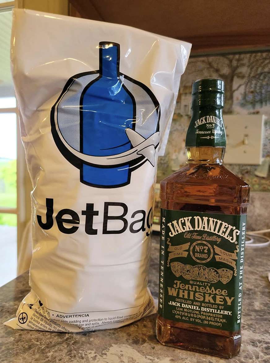 A jet bag next to a bottle of Jack Daniel&#x27;s