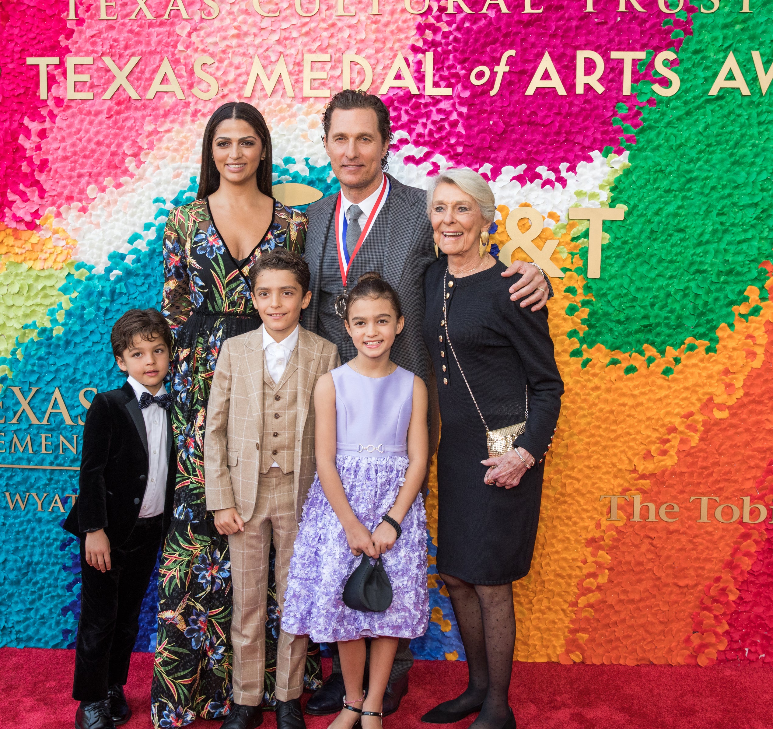 Close-up of Camila and Matthew on the red carpet with their family