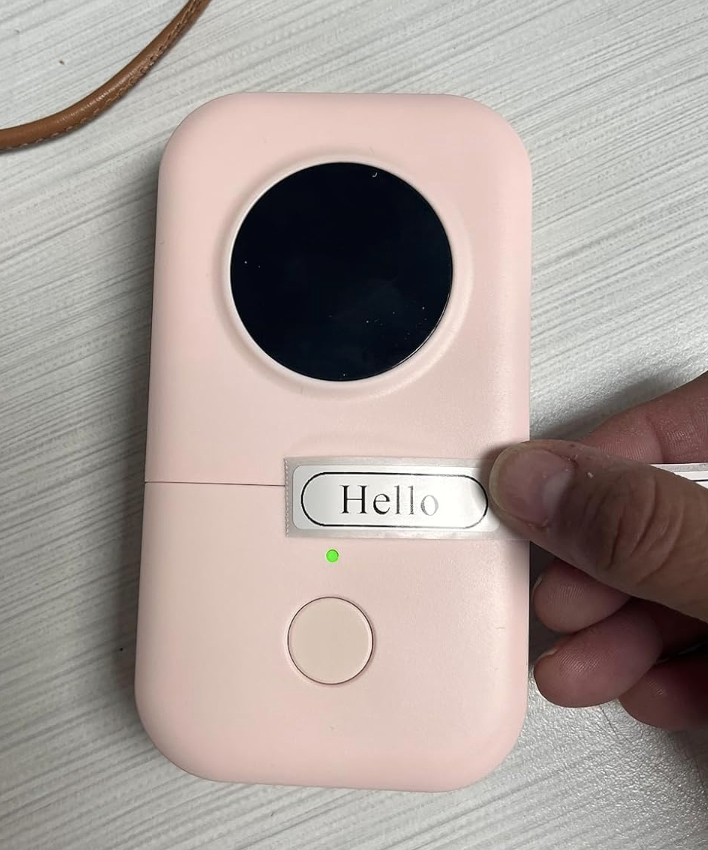 A label maker with a sticker on it reading &quot;hello&quot;