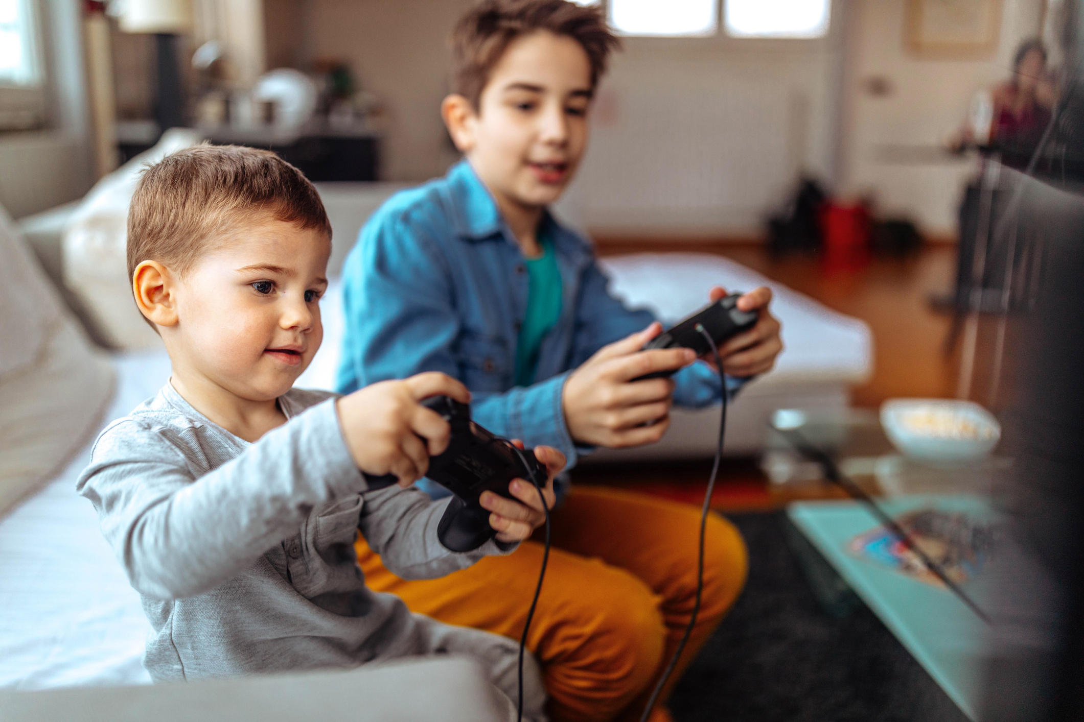 children playing with video games at home